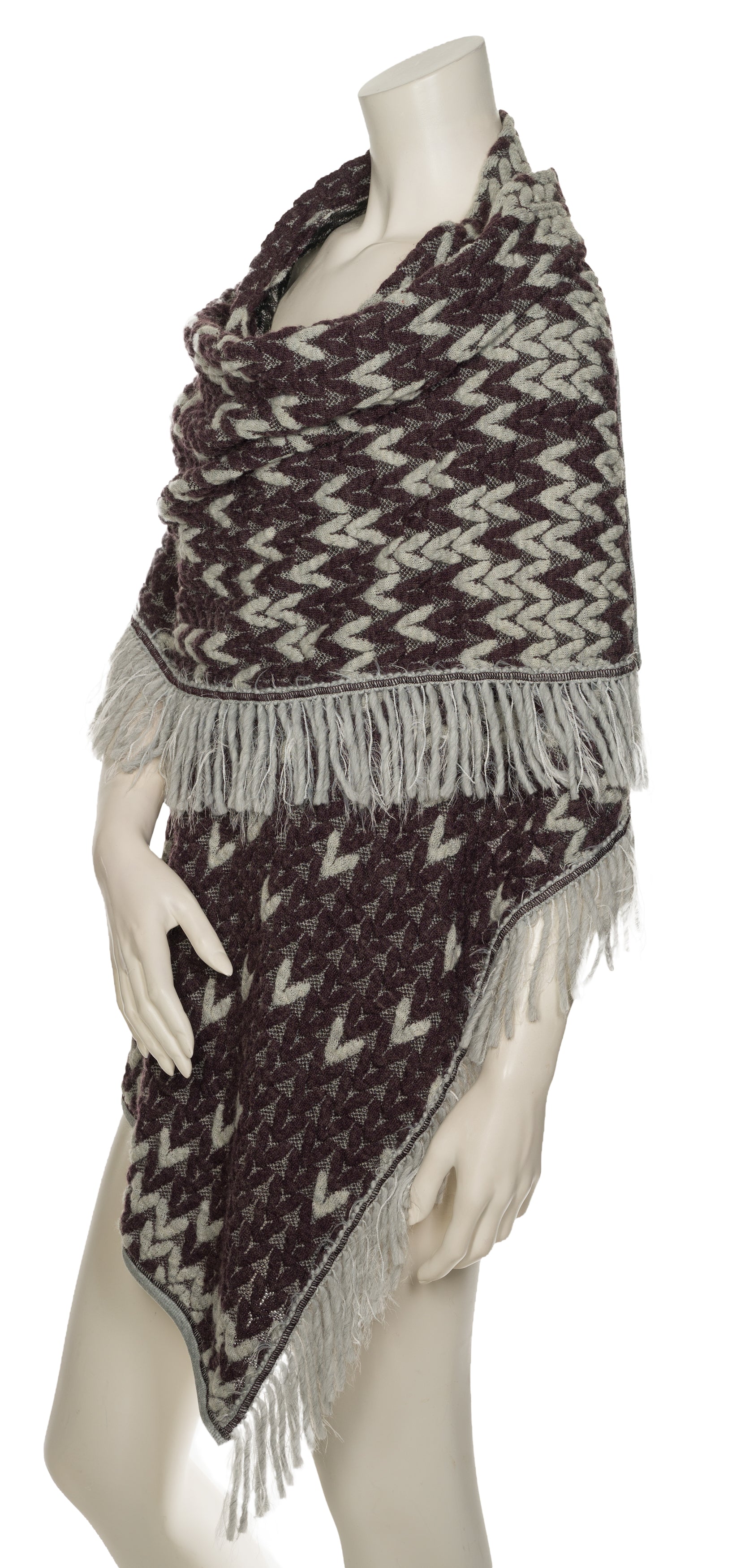 Knit poncho with fringe, and a purple and gray pattern.